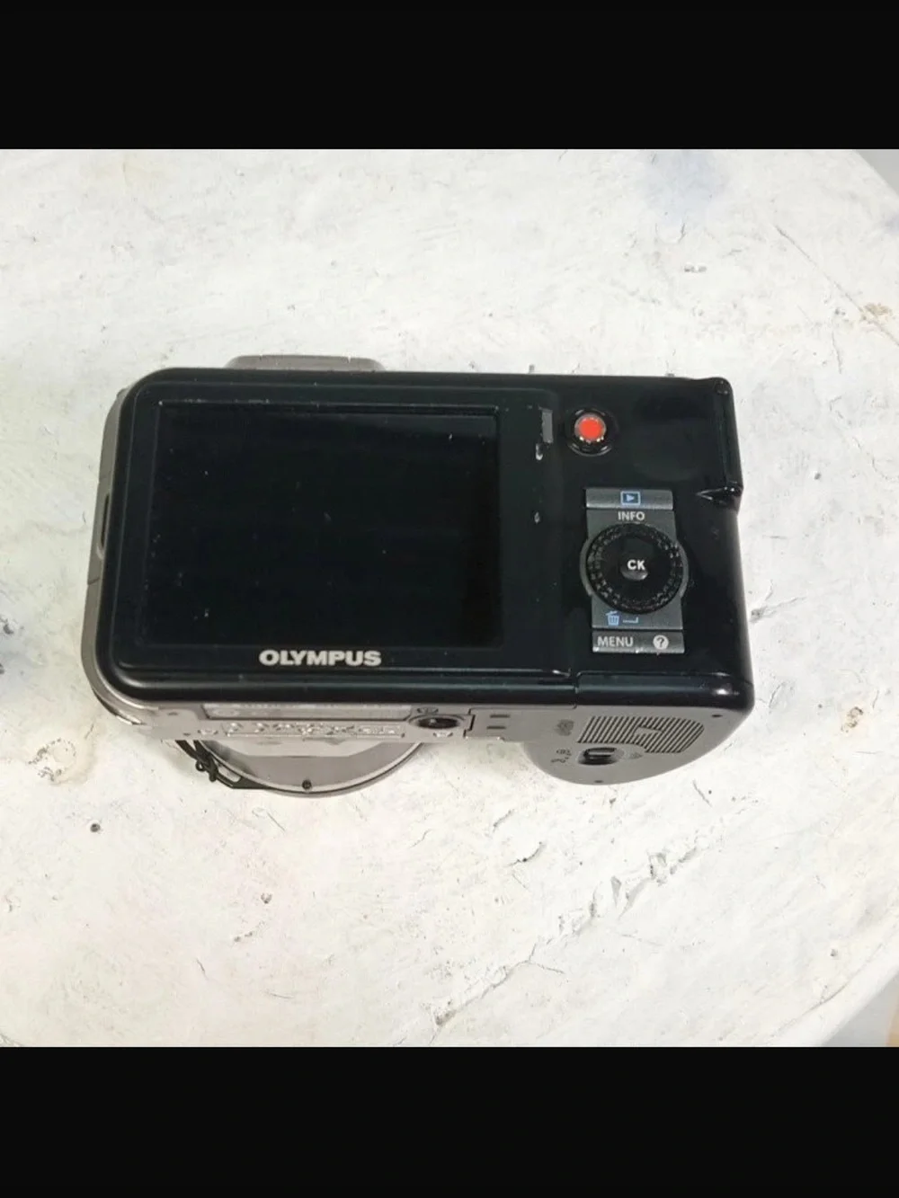 Olympus Silver Digital Camera with Black Grip and Lens Cap